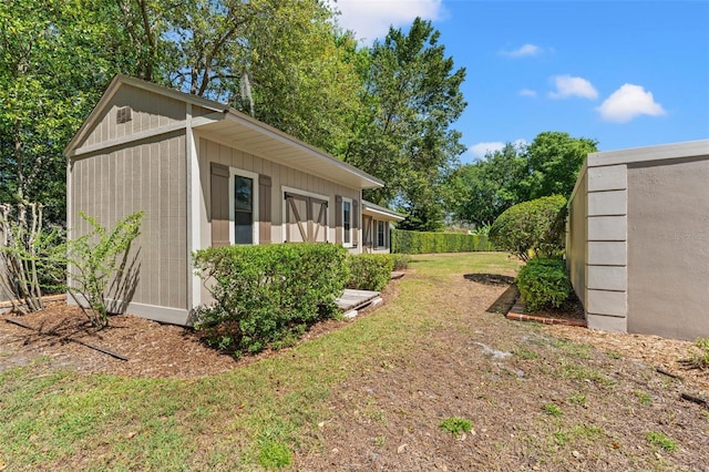 20315 Mid Ct, Lutz, FL 33558 - view of property exterior featuring a lawn and an outbuilding