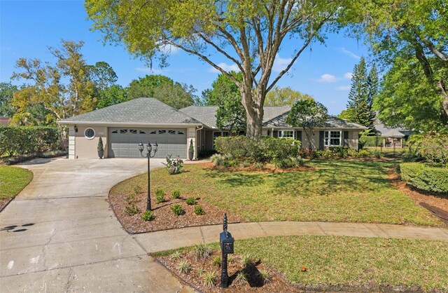 20315 Mid Ct, Lutz, FL 33558 - view of front of property featuring concrete driveway, an attached garage, and a front lawn