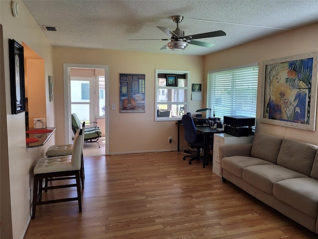 9870 36th Way N, Pinellas Park, FL 33782 - home office featuring wood finished floors, a ceiling fan, a textured ceiling, and baseboards