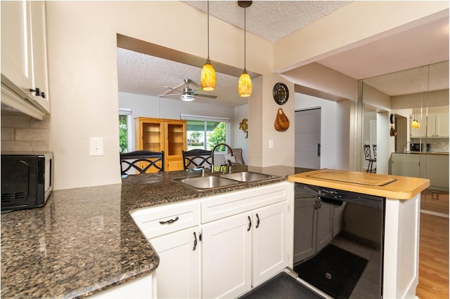 9870 36th Way N, Pinellas Park, FL 33782 - kitchen with a sink, black appliances, a textured ceiling, a peninsula, and white cabinets