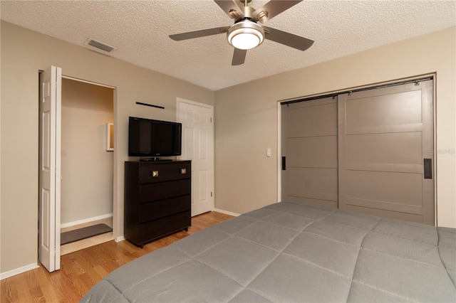 9870 36th Way N, Pinellas Park, FL 33782 - unfurnished bedroom with wood finished floors, a textured ceiling, baseboards, and a ceiling fan