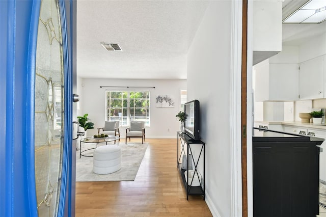 3818 W San Miguel St, Tampa, FL 33629 - interior space featuring visible vents, a textured ceiling, baseboards, and light wood-type flooring