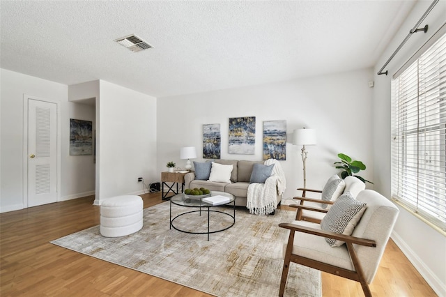 3818 W San Miguel St, Tampa, FL 33629 - living area with wood finished floors, a textured ceiling, baseboards, and visible vents