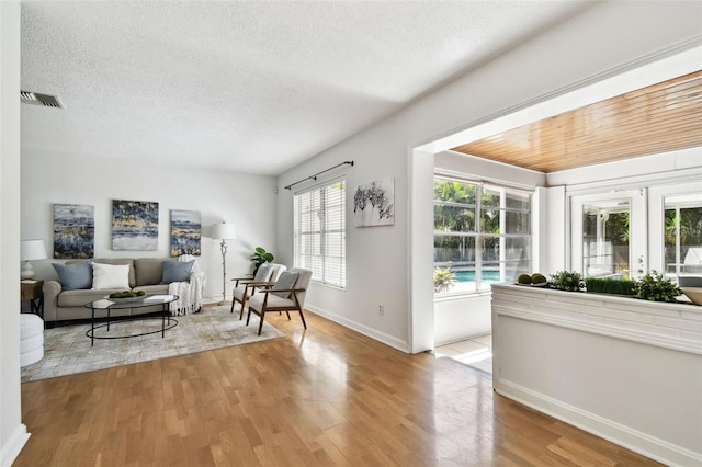 3818 W San Miguel St, Tampa, FL 33629 - living area featuring baseboards, visible vents, wood finished floors, and a textured ceiling