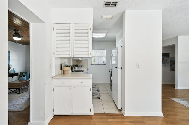 3818 W San Miguel St, Tampa, FL 33629 - kitchen featuring freestanding refrigerator, light countertops, a sink, and visible vents