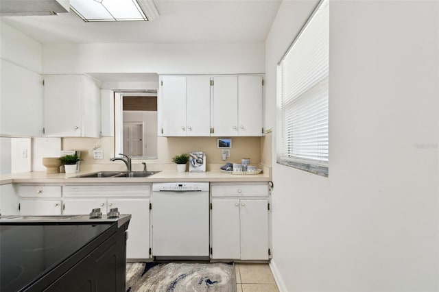 3818 W San Miguel St, Tampa, FL 33629 - kitchen with white cabinets, light countertops, a sink, white dishwasher, and light tile patterned floors