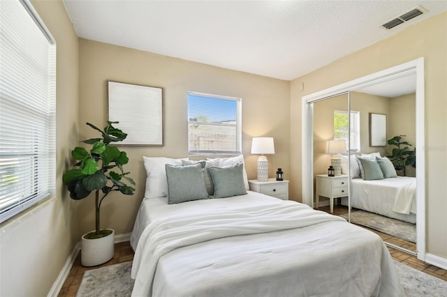 3818 W San Miguel St, Tampa, FL 33629 - bedroom with wood finished floors, baseboards, a closet, and visible vents