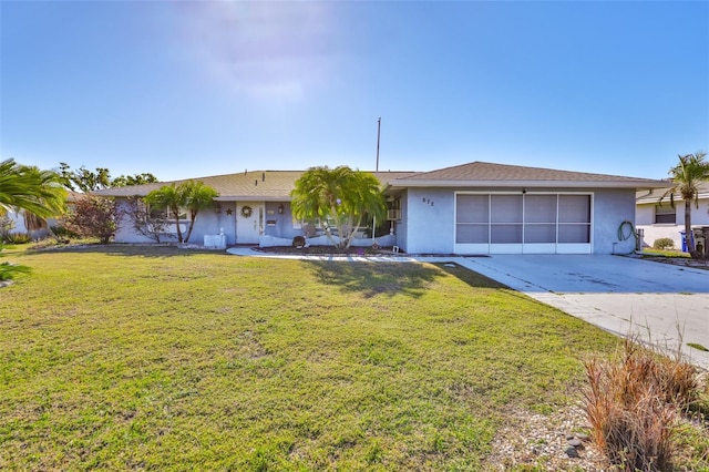 ranch-style home featuring stucco siding, a garage, concrete driveway, and a front lawn