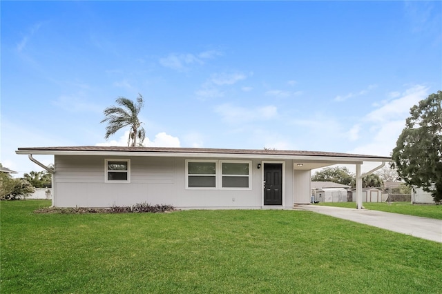 ranch-style house featuring an attached carport, a front yard, fence, and driveway
