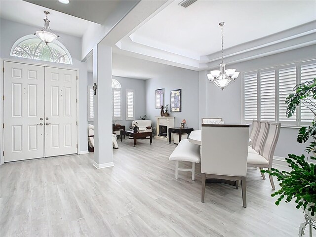 2327 Shirecrest Cove Way, Lutz, FL 33558 - foyer featuring a chandelier, light wood-type flooring, and a tray ceiling