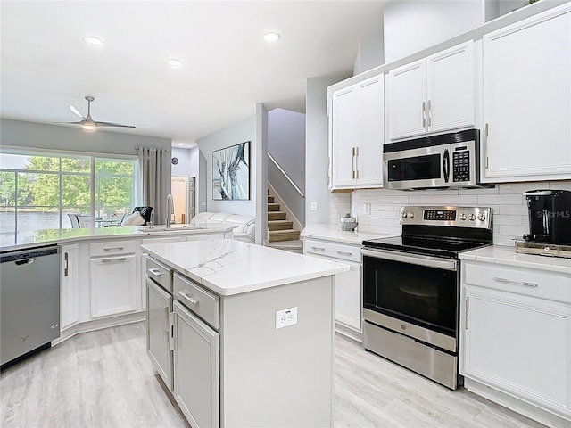 2327 Shirecrest Cove Way, Lutz, FL 33558 - kitchen featuring appliances with stainless steel finishes, light wood-style flooring, backsplash, and recessed lighting