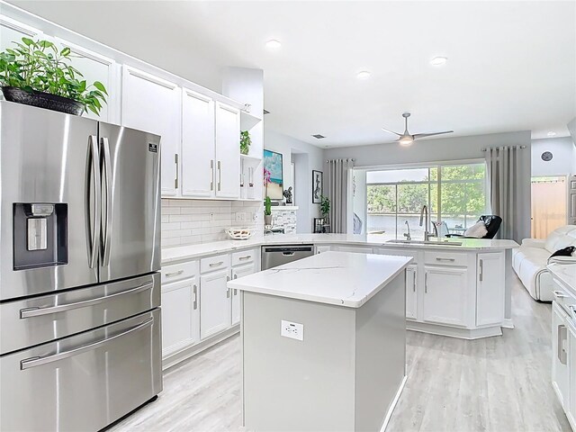 2327 Shirecrest Cove Way, Lutz, FL 33558 - kitchen with stainless steel appliances, a peninsula, light wood-type flooring, a center island, and recessed lighting