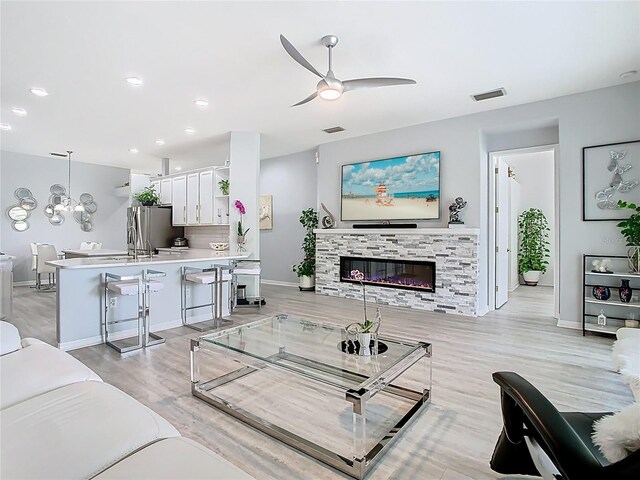 2327 Shirecrest Cove Way, Lutz, FL 33558 - living room featuring ceiling fan, a fireplace, light wood finished floors, and recessed lighting