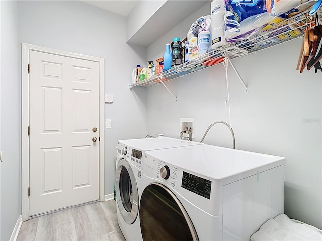 2327 Shirecrest Cove Way, Lutz, FL 33558 - laundry area with light wood-type flooring and independent washer and dryer