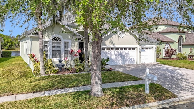 2327 Shirecrest Cove Way, Lutz, FL 33558 - view of front facade with driveway, stucco siding, a garage, and a front yard