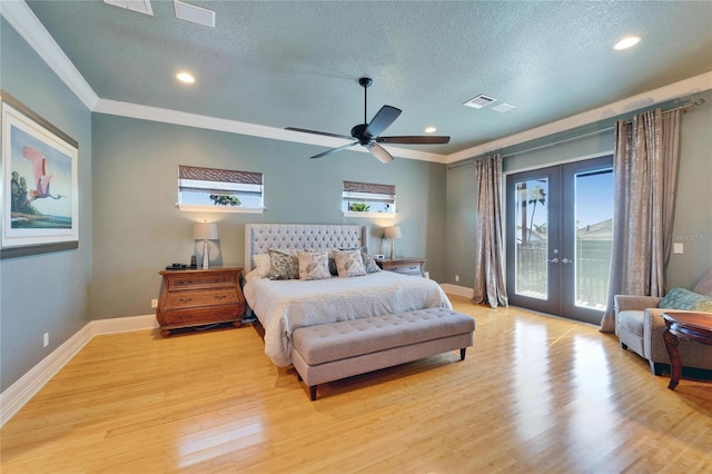 bedroom featuring a textured ceiling, french doors, light wood finished floors, ornamental molding, and access to exterior