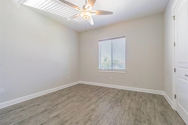 16 Franklin Ct S Unit A, Saint Petersburg, FL 33711 - unfurnished room featuring baseboards, a ceiling fan, and wood finished floors
