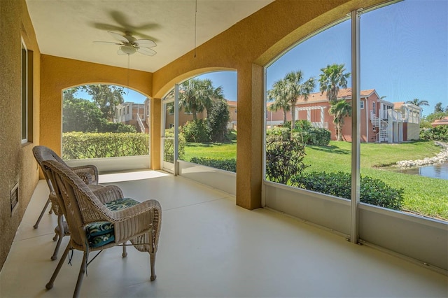 16 Franklin Ct S Unit A, Saint Petersburg, FL 33711 - sunroom with a textured wall, a ceiling fan, and concrete floors