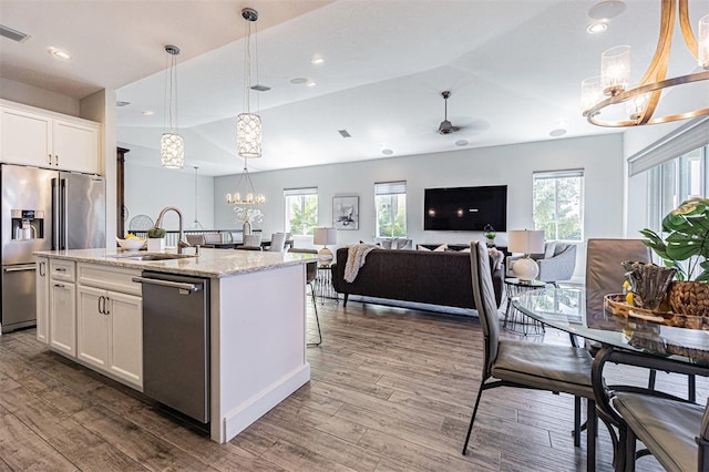 16 Franklin Ct S Unit A, Saint Petersburg, FL 33711 - kitchen featuring a healthy amount of sunlight, stainless steel appliances, a sink, and ceiling fan with notable chandelier