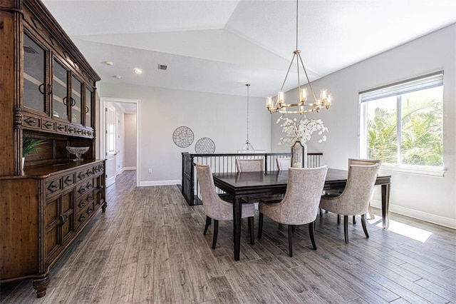 16 Franklin Ct S Unit A, Saint Petersburg, FL 33711 - dining space with wood finished floors, visible vents, vaulted ceiling, a chandelier, and baseboards