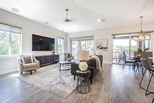 16 Franklin Ct S Unit A, Saint Petersburg, FL 33711 - living area featuring baseboards, wood finished floors, plenty of natural light, and ceiling fan with notable chandelier