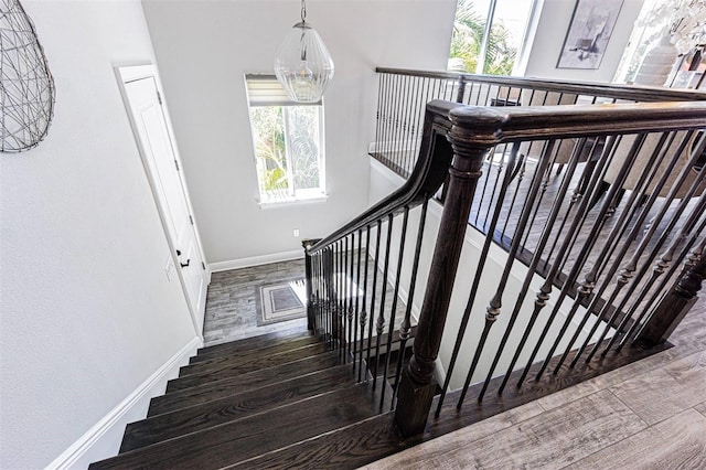 16 Franklin Ct S Unit A, Saint Petersburg, FL 33711 - staircase featuring baseboards and wood finished floors