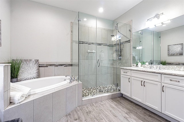 16 Franklin Ct S Unit A, Saint Petersburg, FL 33711 - full bath with wood finished floors, vanity, recessed lighting, a stall shower, and a bath