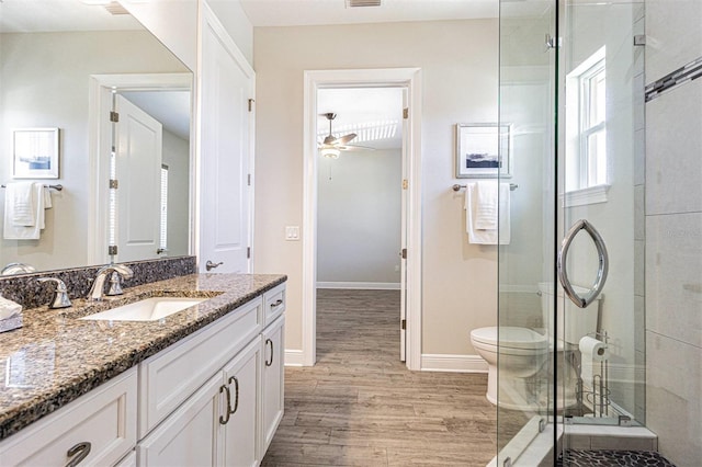 16 Franklin Ct S Unit A, Saint Petersburg, FL 33711 - bathroom with wood finished floors, vanity, a shower stall, a ceiling fan, and baseboards