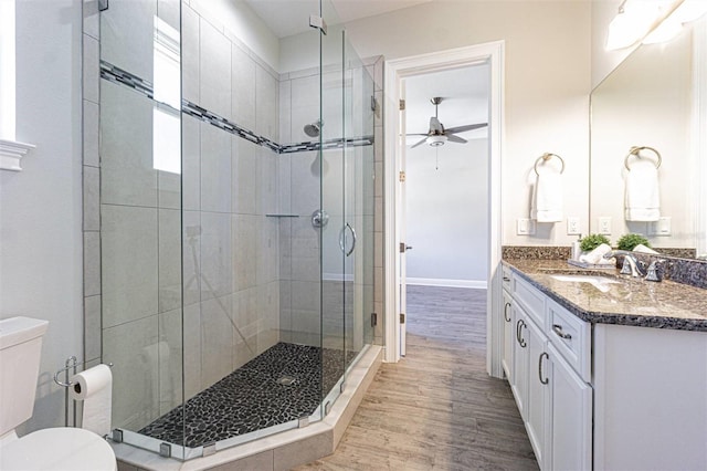 16 Franklin Ct S Unit A, Saint Petersburg, FL 33711 - bathroom featuring toilet, wood finished floors, a ceiling fan, a shower stall, and vanity