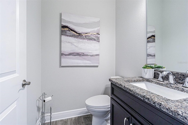 16 Franklin Ct S Unit A, Saint Petersburg, FL 33711 - bathroom featuring toilet, baseboards, wood finished floors, and vanity