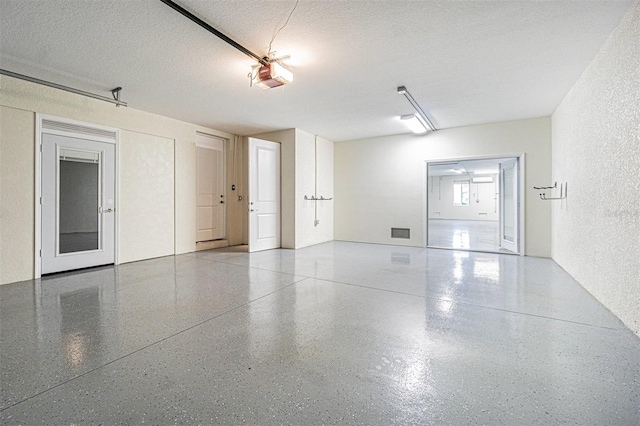 16 Franklin Ct S Unit A, Saint Petersburg, FL 33711 - garage featuring a textured wall and a garage door opener
