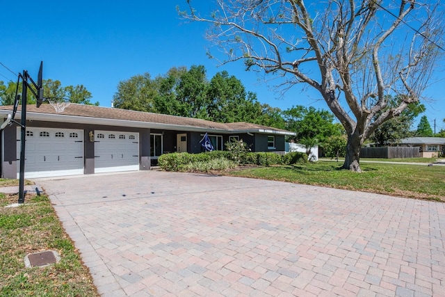 1828 Stancel Dr, Clearwater, FL 33764 - single story home with decorative driveway, a front yard, an attached garage, and stucco siding