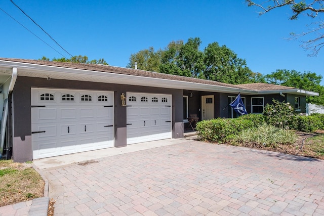 1828 Stancel Dr, Clearwater, FL 33764 - single story home featuring decorative driveway, an attached garage, and stucco siding