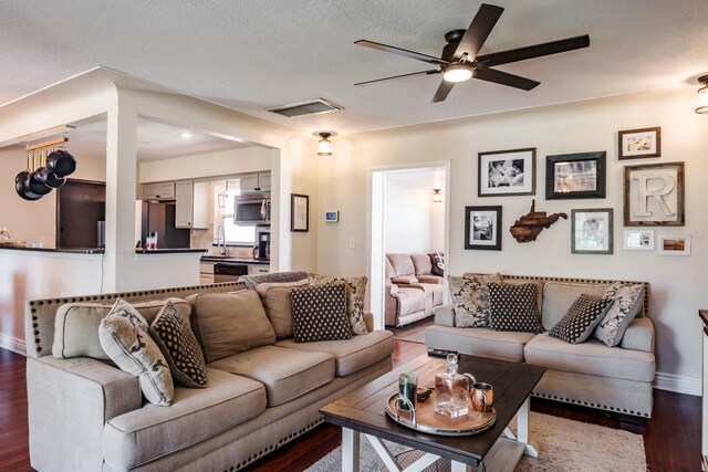 1828 Stancel Dr, Clearwater, FL 33764 - living room with visible vents, a textured ceiling, wood finished floors, baseboards, and ceiling fan