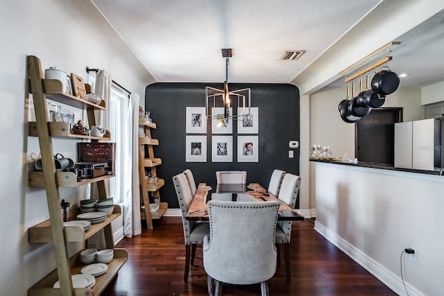 1828 Stancel Dr, Clearwater, FL 33764 - dining room with visible vents, wood finished floors, baseboards, and a chandelier