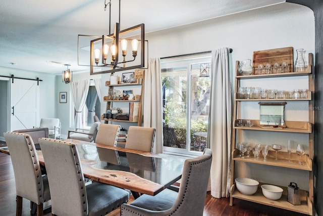 1828 Stancel Dr, Clearwater, FL 33764 - dining area with dark wood finished floors, a barn door, and a chandelier