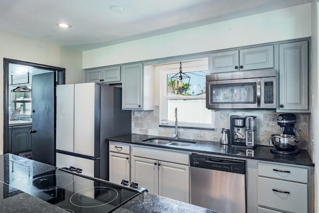 1828 Stancel Dr, Clearwater, FL 33764 - kitchen with dark stone counters, recessed lighting, a sink, decorative backsplash, and stainless steel appliances