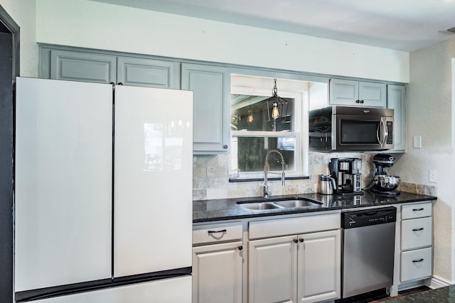 1828 Stancel Dr, Clearwater, FL 33764 - kitchen with visible vents, a sink, appliances with stainless steel finishes, a textured wall, and backsplash