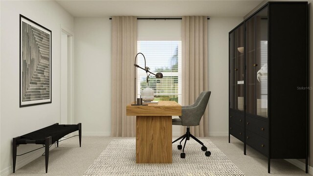 office area featuring baseboards and light carpet
