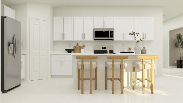 kitchen with white cabinetry, light countertops, a kitchen bar, and stainless steel appliances
