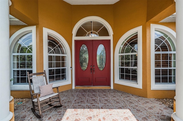entrance to property with stucco siding