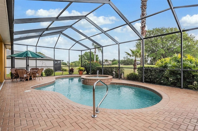 view of swimming pool featuring a pool with connected hot tub, a lanai, and a patio area