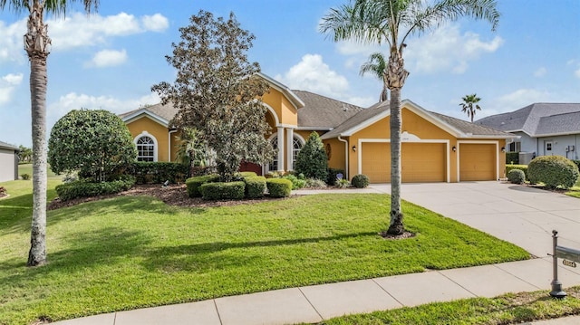 view of front facade featuring a front lawn, stucco siding, an attached garage, and concrete driveway