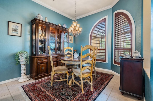 dining room featuring tile patterned floors, baseboards, ornamental molding, and an inviting chandelier