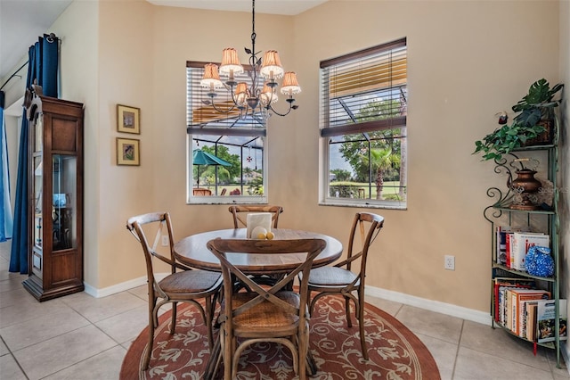 dining area featuring baseboards, light tile patterned floors, and a chandelier