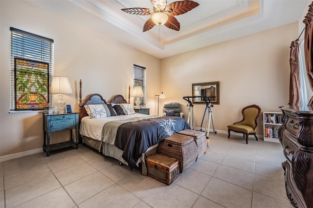 bedroom with baseboards, ornamental molding, light tile patterned floors, and a raised ceiling