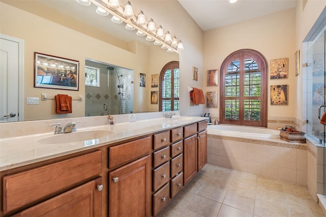 full bathroom with a sink, a stall shower, and a bath