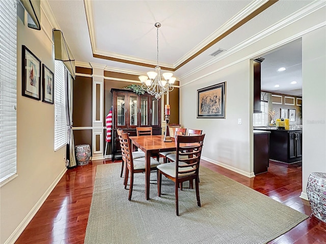 dining space with dark wood-type flooring, visible vents, and plenty of natural light