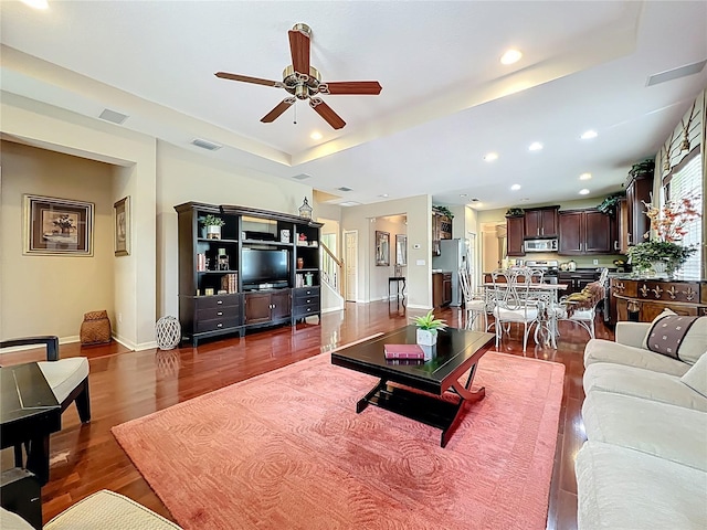 living area featuring recessed lighting, visible vents, a ceiling fan, baseboards, and dark wood-style flooring