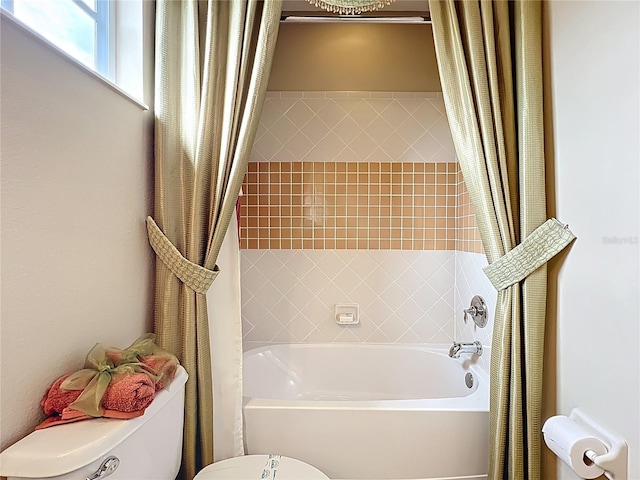 full bathroom featuring shower / tub combo and toilet